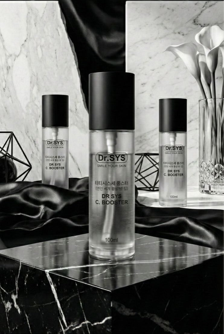 Cosmetic bottles with black labels on a marble surface with decorative elements.