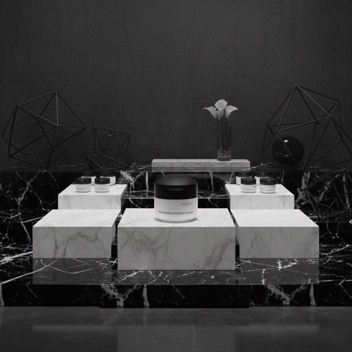 Black and white product display with geometric design and spotlights