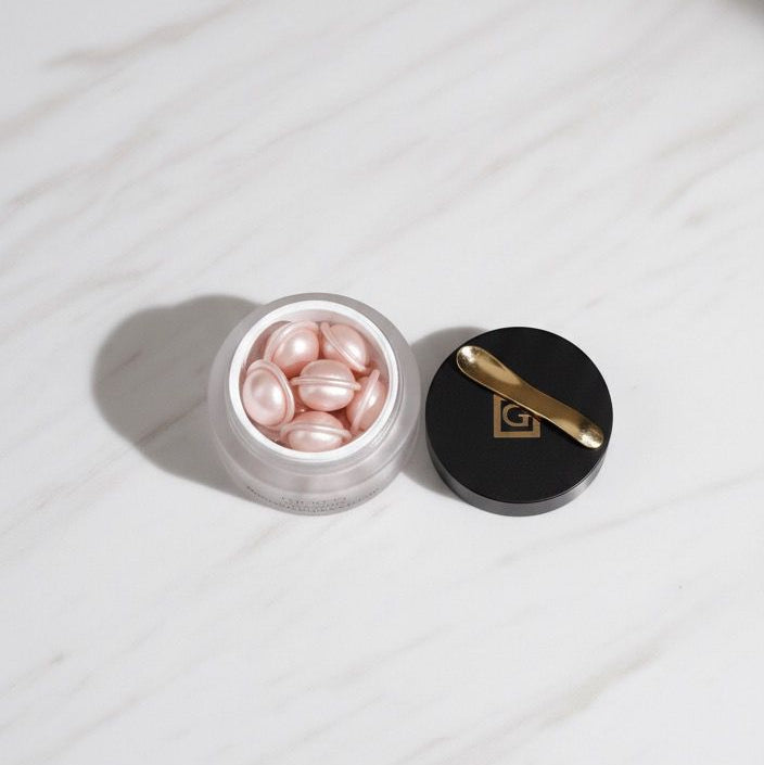 Makeup compact with pink powder on a white marble surface