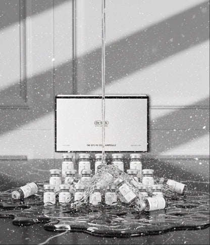 Black and white image of a product display with bottles and a screen.